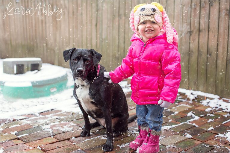Toddler and her Black Lab in the Snow in Irwin, PA