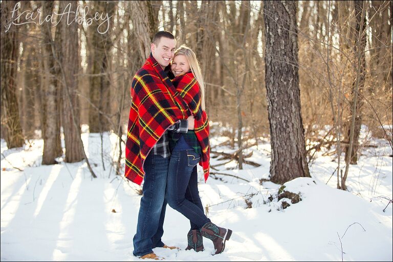 Snowy Winter Engagement Photos at Golden Hour with Red Plaid Blanket