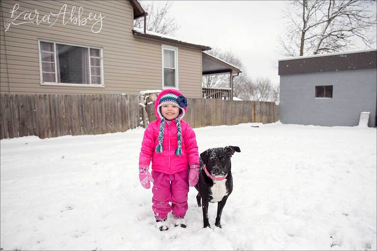 Black Lab & Toddler Playing in their Backyard in the Snow in Irwin, PA