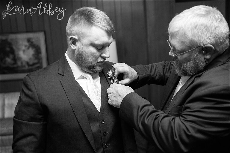 Groom's Dad pinning boutonniere onto his son