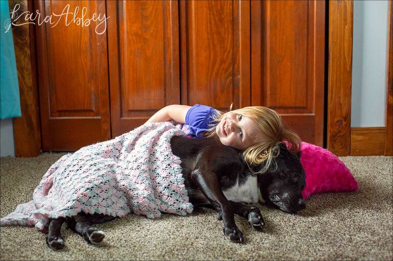 Toddler Laying on Black Lab with Pillow & Blanket
