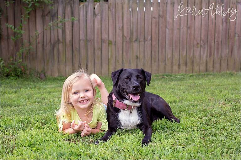 Black Lab & Toddler Laying in the Grass in the Backyard in Irwin, PA