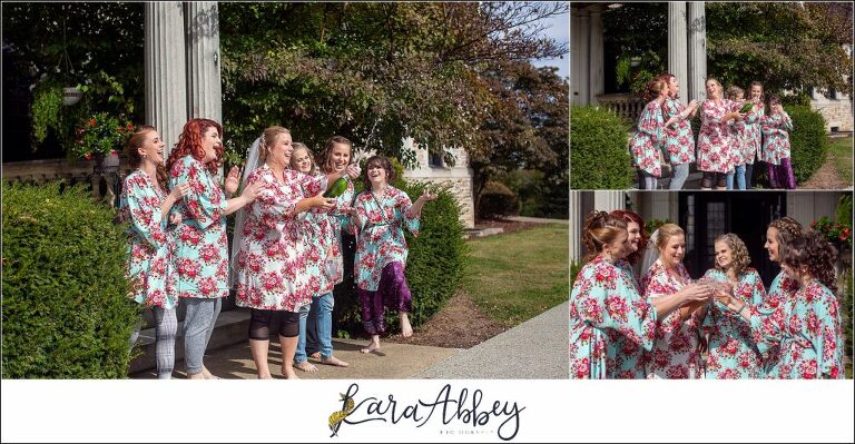 Maroon Fairy Tail Fall Wedding at Linden Hall Mansion in Dawson, PA - Bride & Bridesmaids in Colorful Robes Popping Champagne