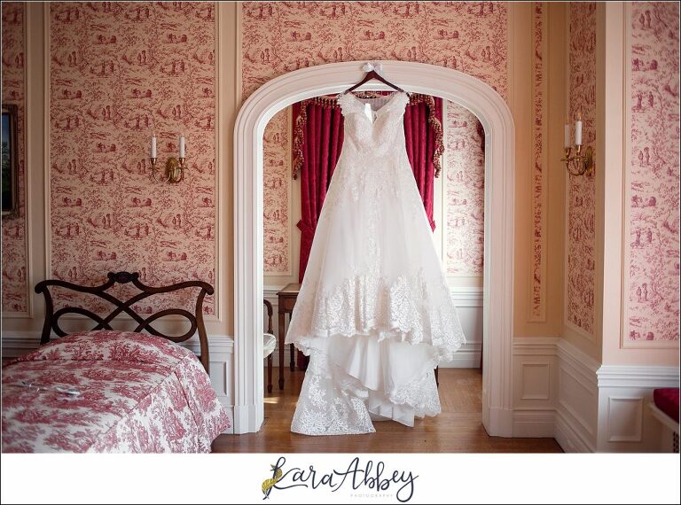 Maroon Fairy Tail Fall Wedding at Linden Hall Mansion in Dawson, PA - Bride's Gown Hanging in Red Bedroom