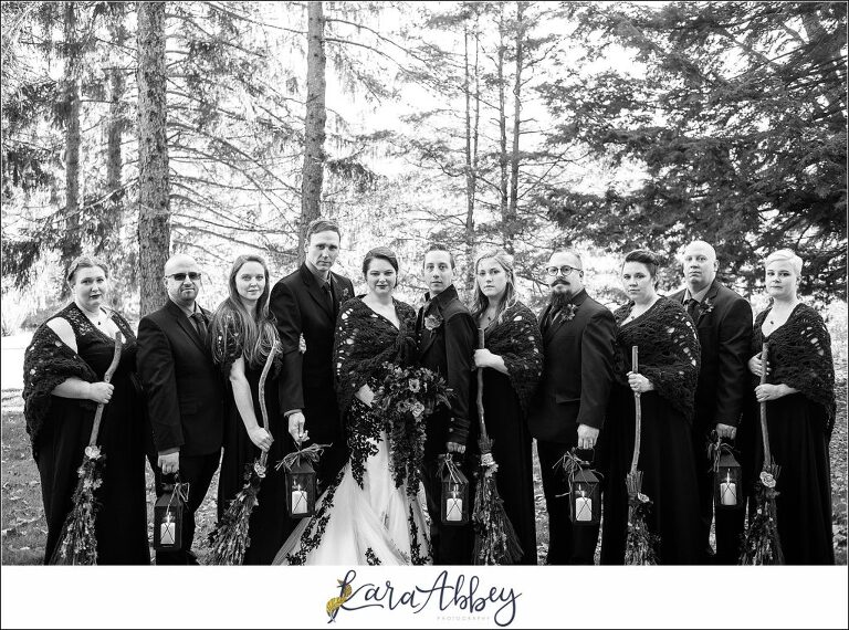 Black and Purple Disney Halloween Themed Fall Wedding at Green Gables in Jennerstown PA - Bridal Party Portrait Carrying Brooms & Lanterns
