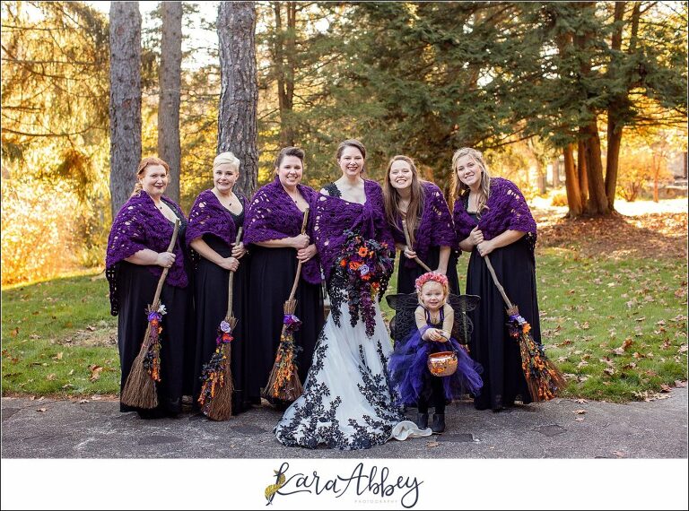 Black and Purple Disney Halloween Themed Fall Wedding at Green Gables in Jennerstown PA - Bridesmaids Portrait Carrying Brooms