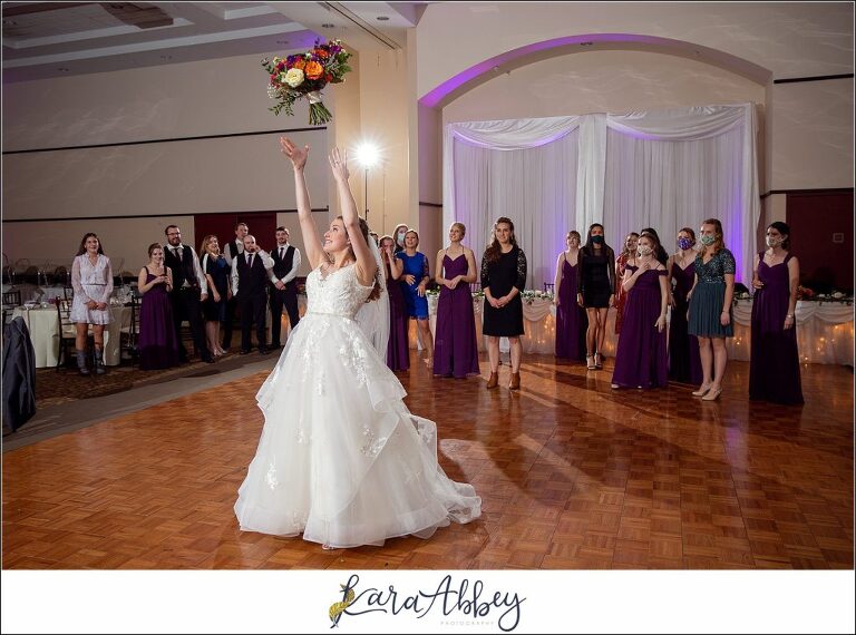 Elegant Purple Fall Wedding Reception at The Holy Trinity Center in Pittsburgh, PA - Bride Tossing the Bouquet