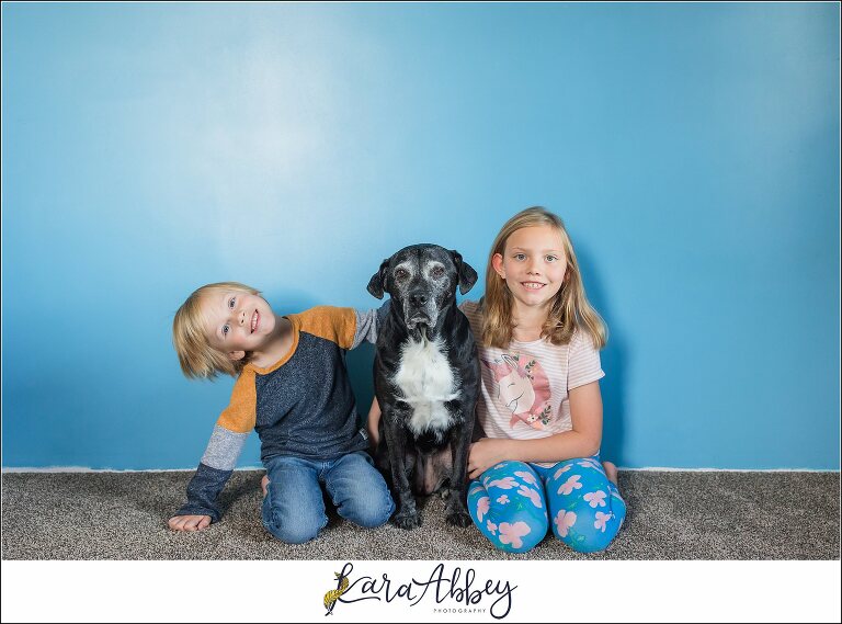 Abbys Saturday Black Lab and Kids Portrait against blue wall in Irwin PA